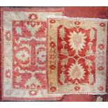 Two small similar red and cream ground wool rugs with floral design 92 cm x 63 cm x 75 cm x 62 cm