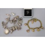 Two silver charm bracelets; one silver gilt example hung with six 9ct novelty charms to include an