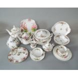 A collection of Royal Albert Moss Rose pattern wares comprising a teapot, milk jug, covered sugar