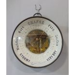Glazed aneroid barometer with open workings and inscribed glass front, 20cm diameter
