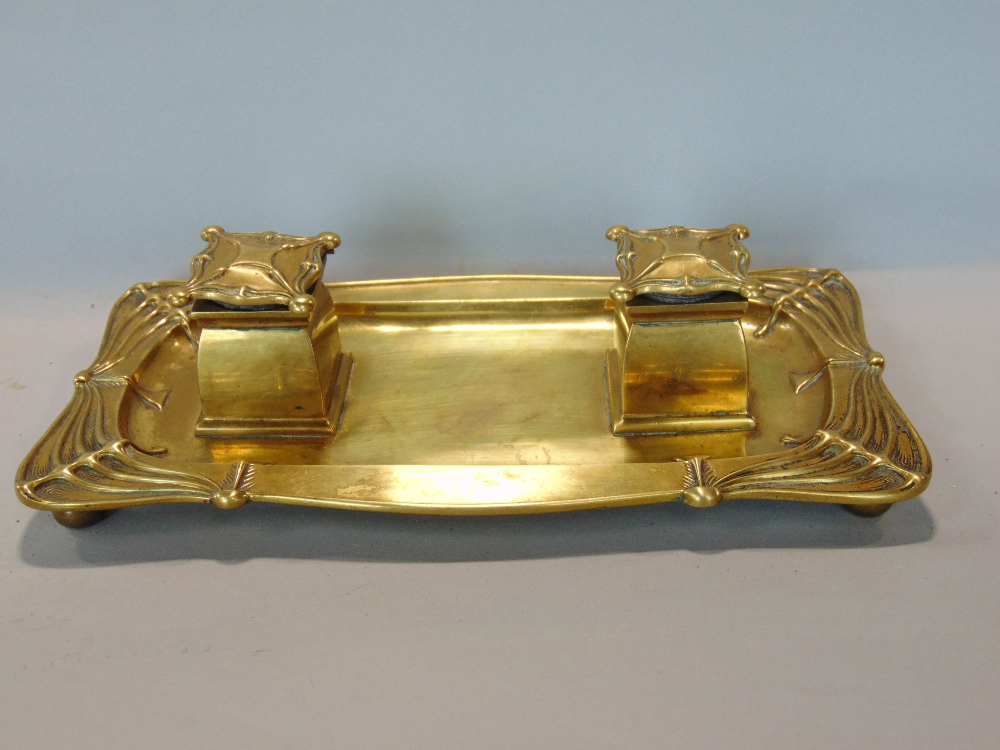 Good quality cast brass Art Nouveau standish fitted with two lidded inkwells upon a shaped