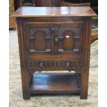 A good quality small Old English style oak side cupboard, enclosed by a pair of arcaded and carved