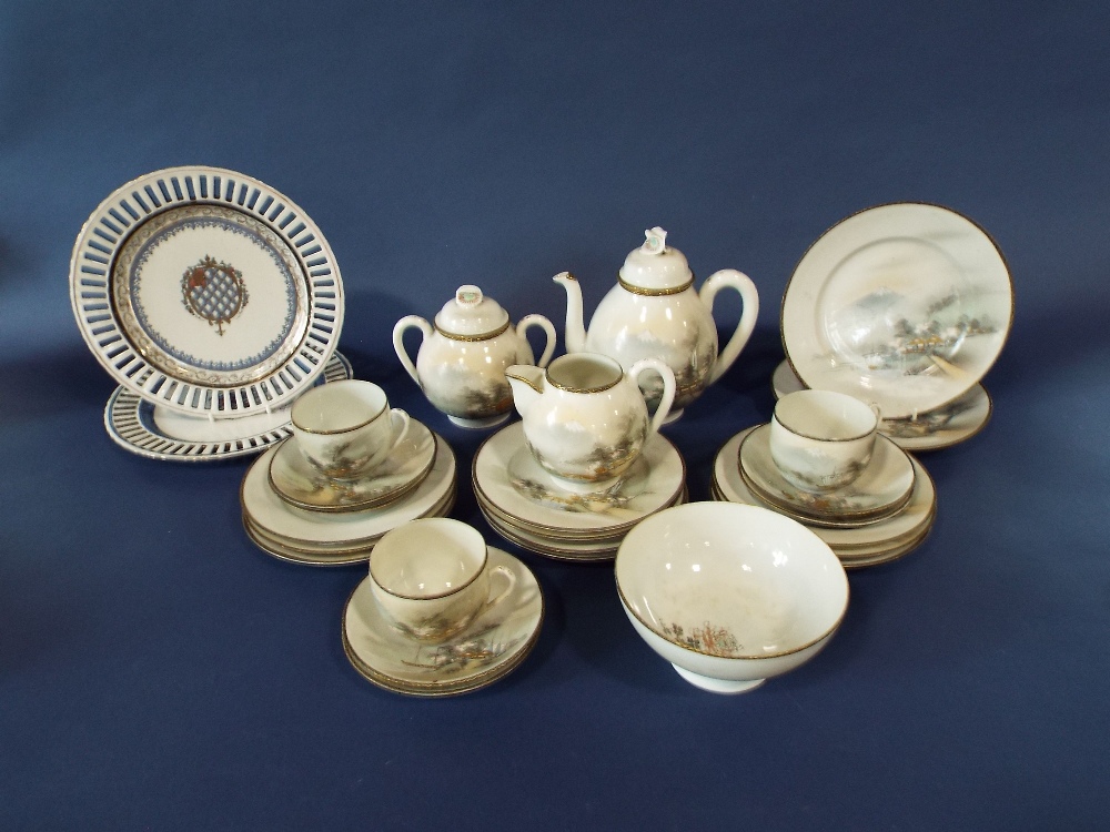 A collection of Japanese eggshell porcelain teawares with painted landscape detail including teapot,