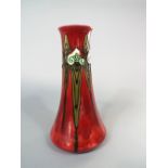 A Minton Seccessionist ware vase with tube lined Art Nouveau style decoration on a red ground and