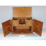 Early 20th century oak smokers cabinet, the panelled front with poker work decoration enclosing