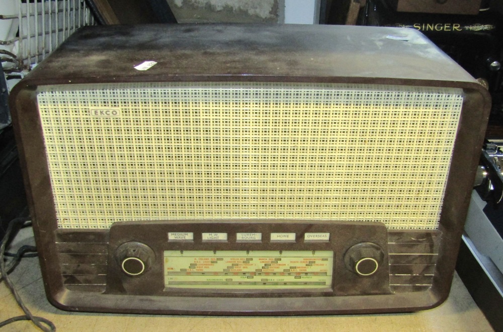 A vintage cased portable Singer sewing machine, together with an Ekco Bakelite cased mains radio