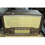 A vintage cased portable Singer sewing machine, together with an Ekco Bakelite cased mains radio