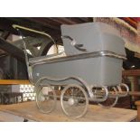 A vintage child's pram, the Souplex, with chrome fittings and wire wheels