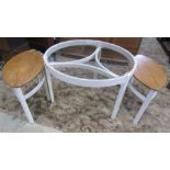 A teak framed coffee table of circular form with inset glass top raised on four square cut legs