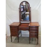 A good quality mahogany kneehole twin pedestal dressing table with rectangular bevelled edge swing