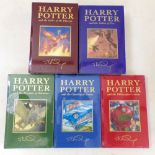 A collection of the first five Harry Potter titles, all deluxe editions with intact original plastic
