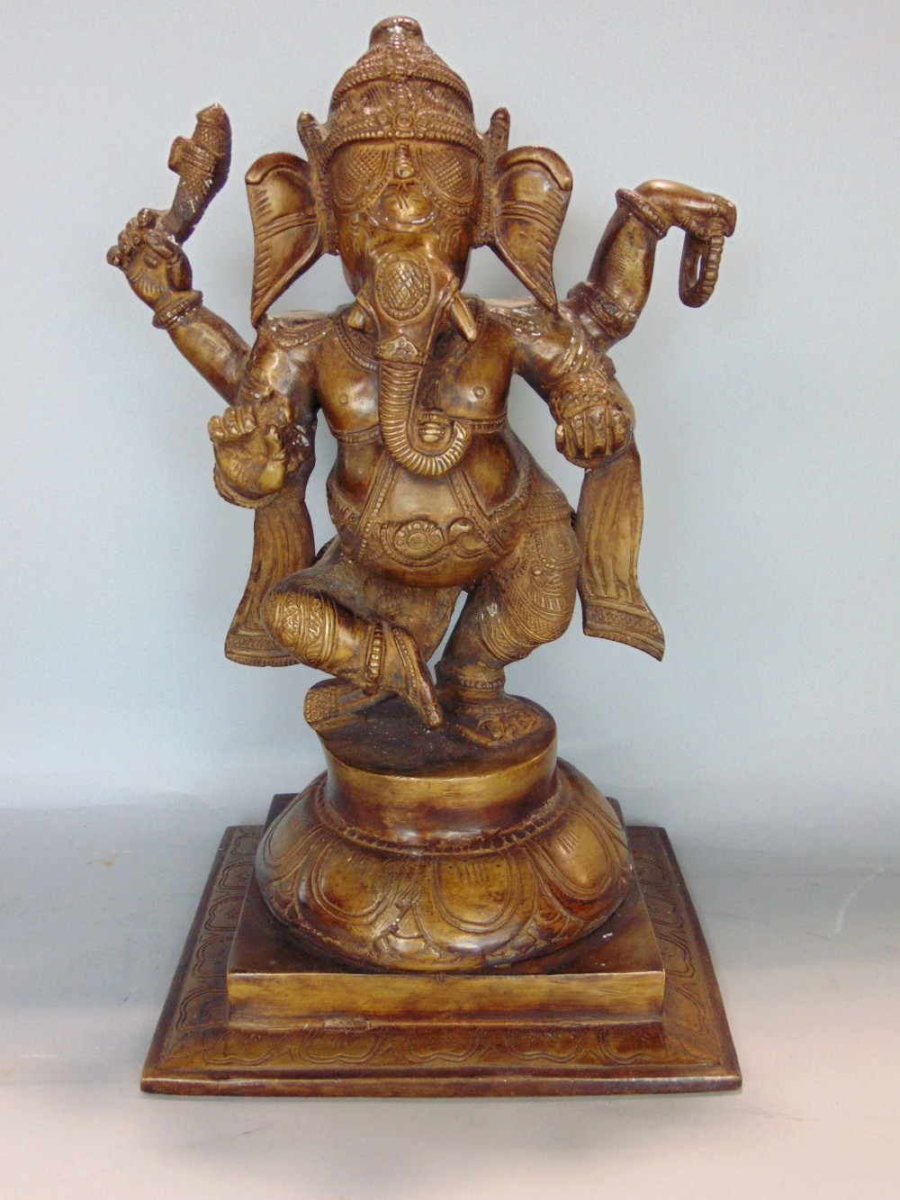 Indian gilt cast bronze figure of Ganesh the elephant god, upon a stepped circular plateau and