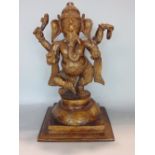 Indian gilt cast bronze figure of Ganesh the elephant god, upon a stepped circular plateau and