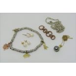 Mixed group of jewellery comprising a silver bracelet hung with three 9ct charms in the form of a