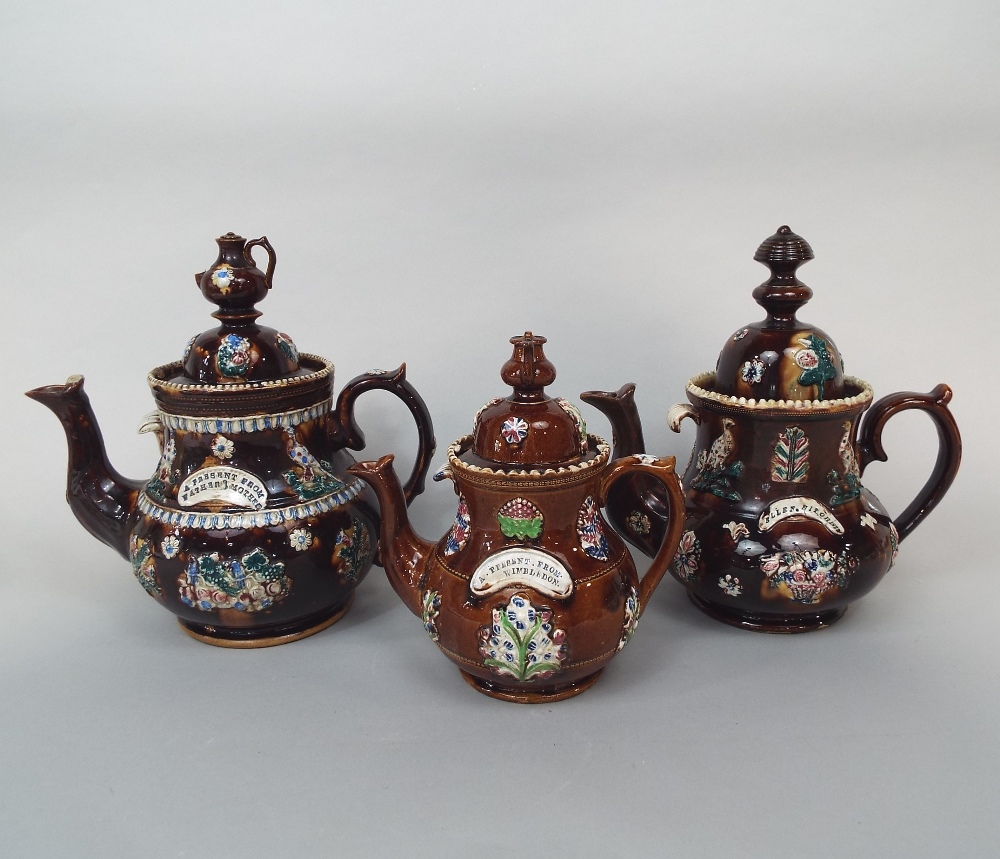 Three 19th century bargeware teapots of usual form with teapot knops and relief moulded