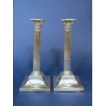 Pair of late George III silver corinthian column candlesticks on good swept square bases with ribbon