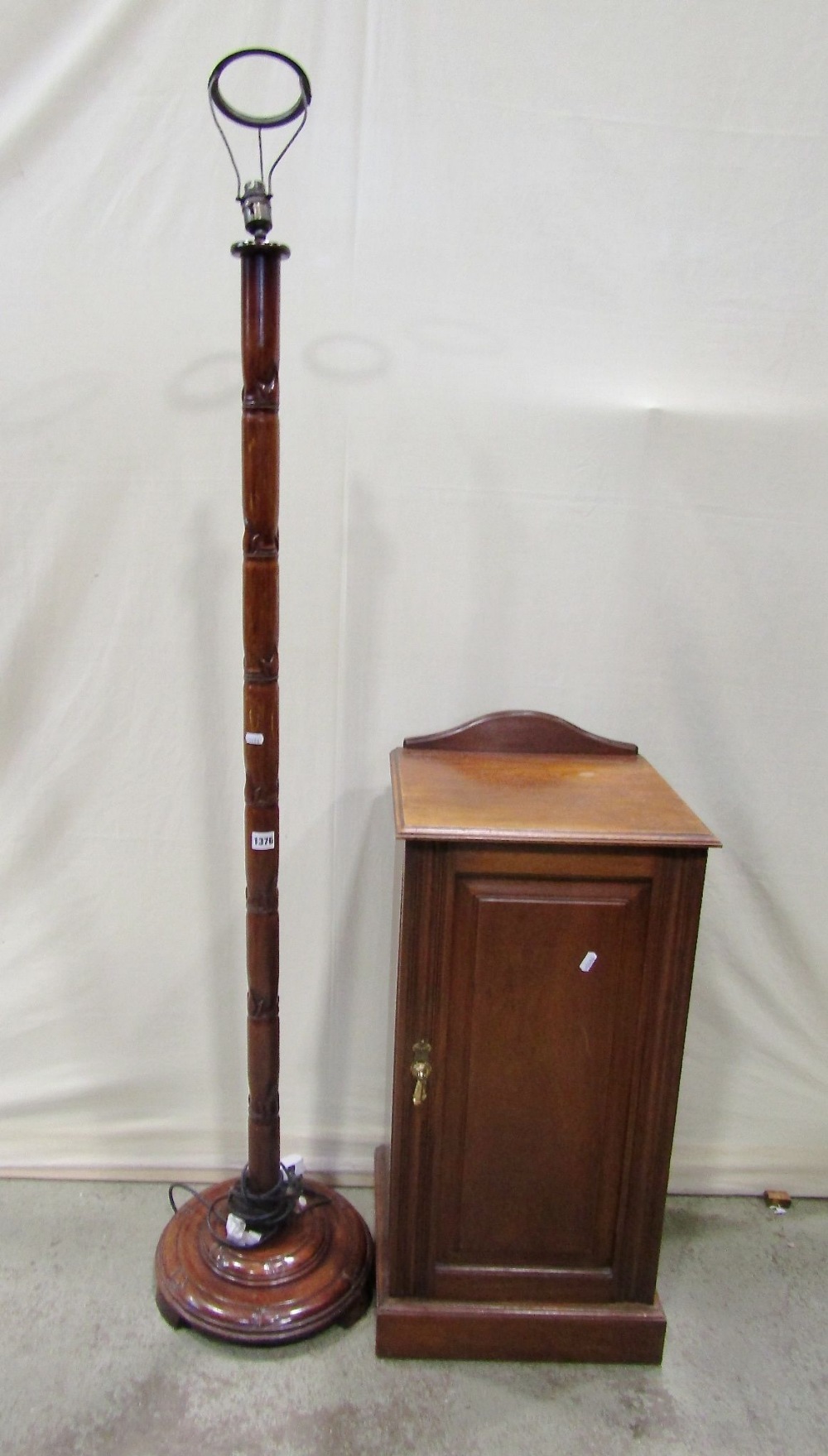 A Chinese hardwood standard lamp with carved simulated bamboo stem and stepped disc shaped