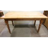 A Victorian style stripped pine kitchen farmhouse table of rectangular form raised on four turned