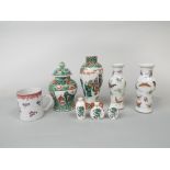 A collection of oriental ceramics including a pair of white ground vases with polychrome butterfly