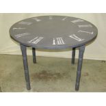 A contemporary pine kitchen table of circular form with painted finish, the top in the form of a