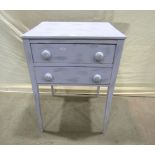 An antique pine side table fitted with two long drawers raised on slender square tapered legs with