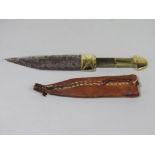 An Eastern dagger with horn handle and polished brass knop, within a leather sheath