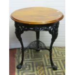 A traditional cast iron Britannia head pub table of circular form, with decorative pierced foliate