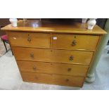 A Victorian stripped pine bedroom chest of two short over three long graduated drawers with