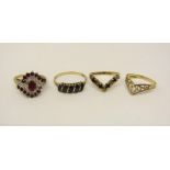 Four 9ct dress rings; a ruby and diamond cluster crossover style ring (one ruby vacant), a blue