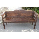 A European stained pine bench/low settle with shaped outline, panelled back and solid seat, 6ft long