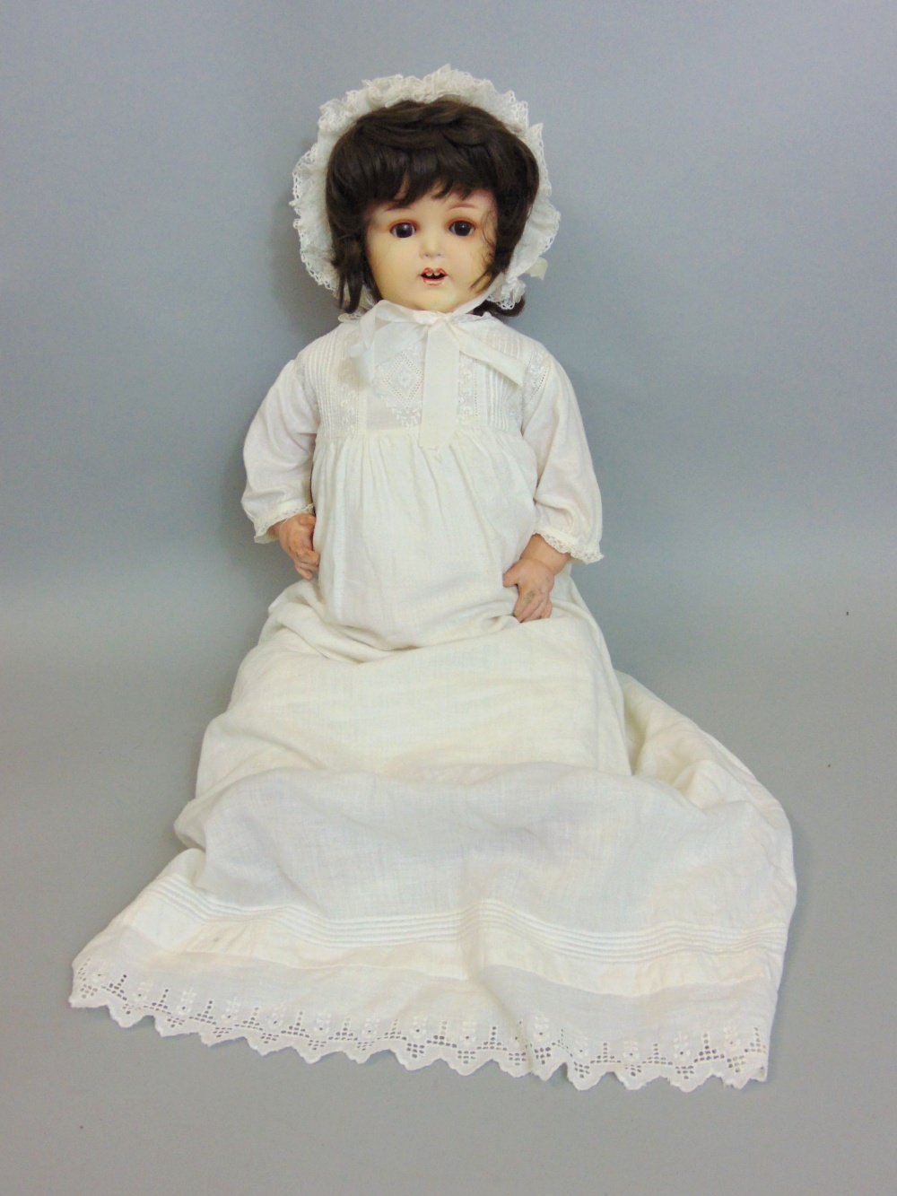 An Armand Marseille bisque head doll mould number 996/10 closing eyes, open mouth in a Victorian