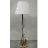 A good quality polished brass and copper standard lamp with domed disc shaped base, scrolled