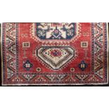 Turkish carpet with three blue medallions upon a washed red and cream ground, 250 x 210 cm