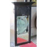 An Old English style oak framed pier glass, with rectangular bevelled edge plate and carved fluted
