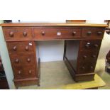 A small Victorian mahogany kneehole twin pedestal writing desk with inset green leather panelled top