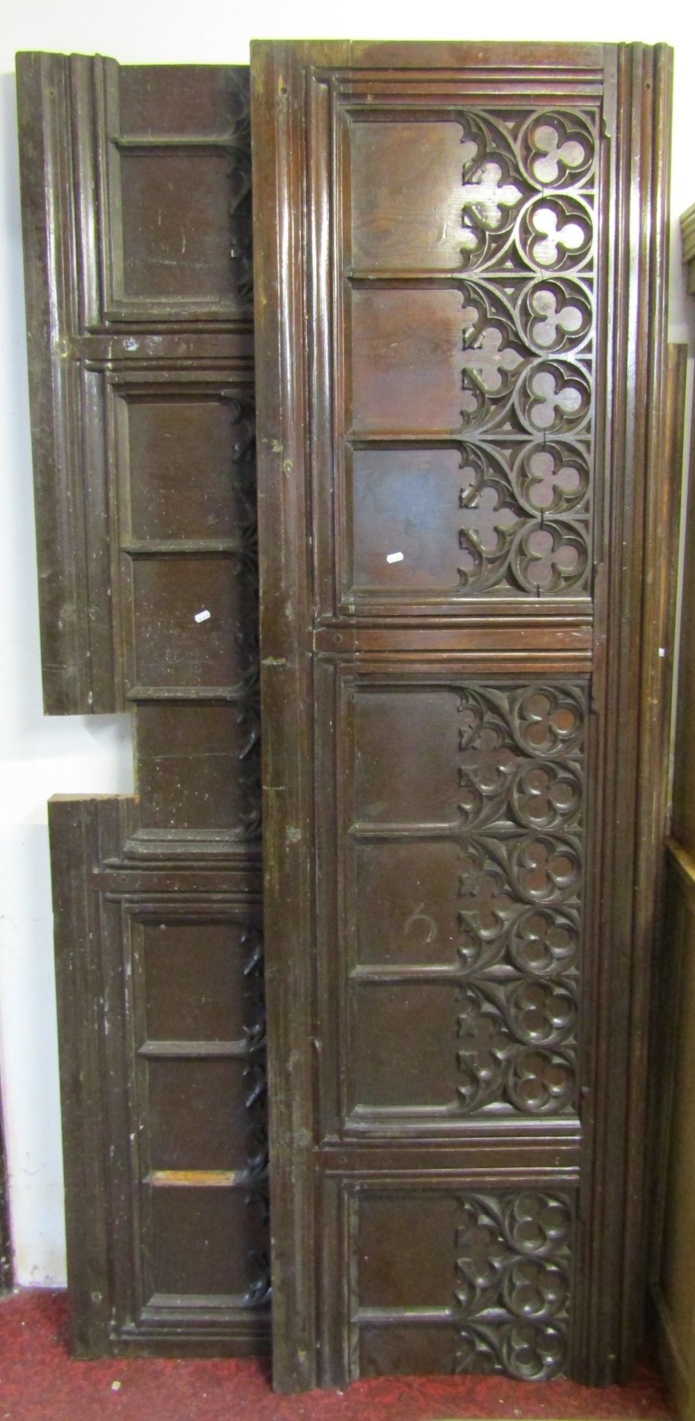 Three reclaimed stained pine runs of ecclesiastical panelling, two with Gothic tracery and moulded