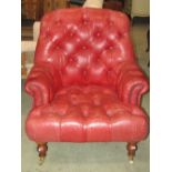 A good quality contemporary armchair with shaped outline and red leather buttoned upholstery, raised