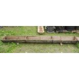 Five vintage rustic wooden sheep feeding troughs of rectangular form raised on sledge feet, three