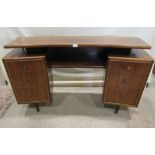 A retro Herbert Gibbs walnut veneered twin pedestal dressing table of curved and canted form, each