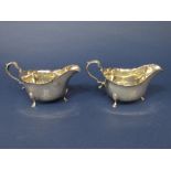 Pair of Georgian style silver boat shaped cream jugs, both engraved with a stylised capital A, maker