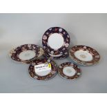 A collection of early 19th century ironstone china dinner wares with printed and infilled border