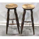 A pair of good quality reproduction ashwood Windsor high stools with circular seats raised on turned