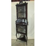 An Edwardian mahogany freestanding corner display cabinet, with pierced fretwork and carved