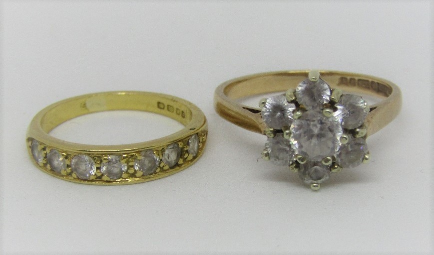 18ct seven stone ring, size J and a 9ct flower head ring, both set with white stones, size O, 6.2g