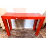 A late 20th century burnt orange lacquered hall/side table of rectangular form with inlaid brass