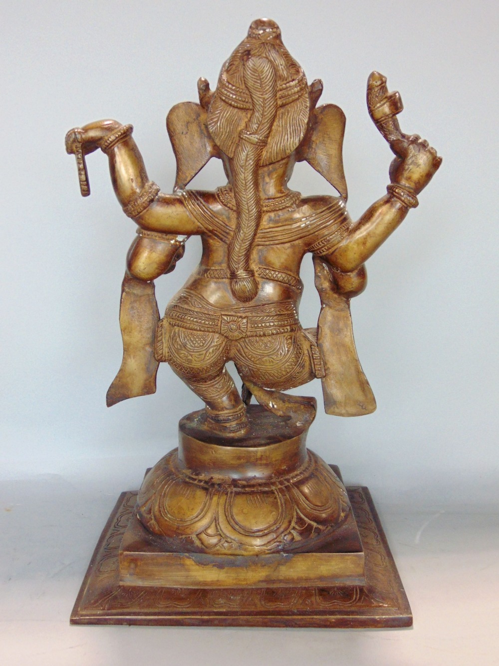 Indian gilt cast bronze figure of Ganesh the elephant god, upon a stepped circular plateau and - Image 2 of 3