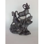 Ebonised cast brass/bronze study of two mountain goats on a naturalistic base, 20cm high