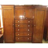 A Victorian pine shallow inverted breakfront triple compactum wardrobe, the central section fitted