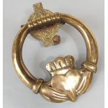 A good polished cast bronze Irish Claddagh door knocker in the form of a crowned heart in a pair