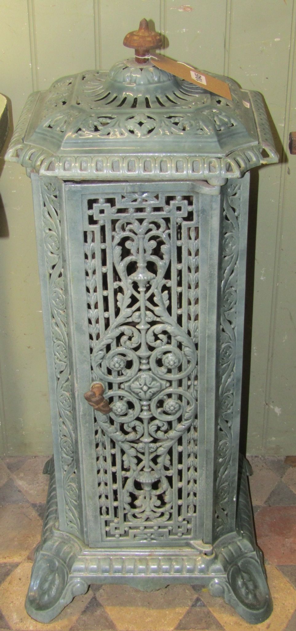 A Victorian cast iron and enamel floor standing conservatory heater of square cut and canted form,